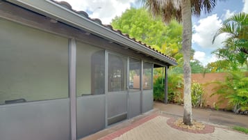 A building with large windows and a covered outdoor area.