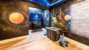 A room with a starry ceiling, a PlayStation TV, a desk with a computer, and a chair. - Pet friendly, upgraded townhouse, with heatable pool, and Jedi themed bedroom (Kissimmee)