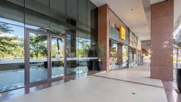 A modern building with large glass windows, a visible entrance, and a sign that reads "Soul".