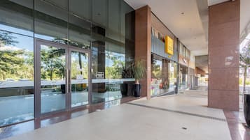 A modern building with large glass windows, a visible entrance, and a sign that reads "Soul".