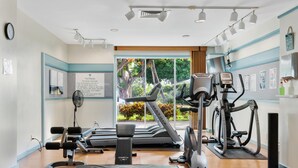 A gym with treadmills, elliptical machines, and weight benches. - Big Island Vista Waikoloa B203 2 Bedroom Condo (Waikoloa)