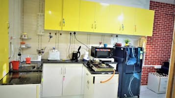 Mini-fridge, dishwasher, coffee/tea maker, cookware/dishes/utensils