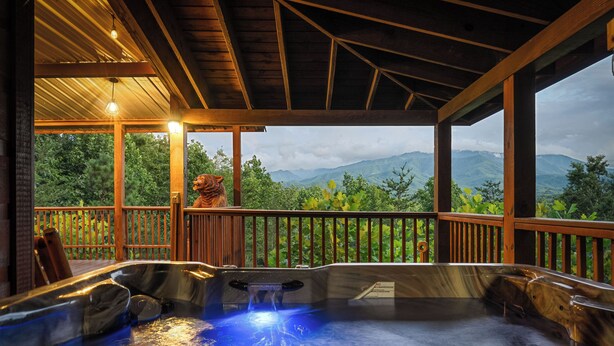 A hot tub area with a wooden deck and a view of mountains. - Private 2+ Acre Ridge-Top Retreat with Hot Tub, Game Room & Stunning Views! (Gatlinburg)