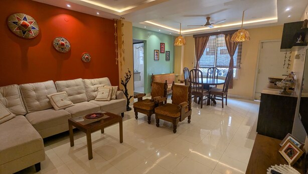 A living room with a sofa, chairs, a coffee table, and a dining area with a table and chairs. - Seneh Homes - An Assamese homestay experience with WiFi, Views, & AC in Guwahati (Guwahati)