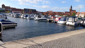 A marina with boats docked along a cobblestone waterfront. - Vacation home Kleine Einkehr - comfortable & quiet in Waren (Müritz), with balcony (Waren (Müritz))