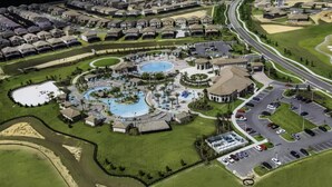 An aerial view of a residential community with a central swimming pool, multiple buildings, and a parking area. - Modern Disney Escape - 4BR - Private Pool (Davenport)