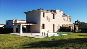 A two-story building with a swimming pool, a covered patio, and a well-maintained lawn. - Apartment 'Florida 2' with Sea View, Wi-Fi and Air Conditioning (San Teodoro)
