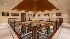 A spacious atrium with a high wooden ceiling, a central chandelier, and a marble floor. - Radisson Resort Mount Abu (Mount Abu)