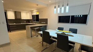 A modern kitchen with a dining area. - Tropical Getaway in Heredia, Costa Rica (Heredia)