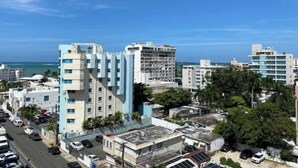 A cityscape with modern buildings, a clear blue sky, and a view of the ocean. - Sofia’s Beach Apartment (Carolina)