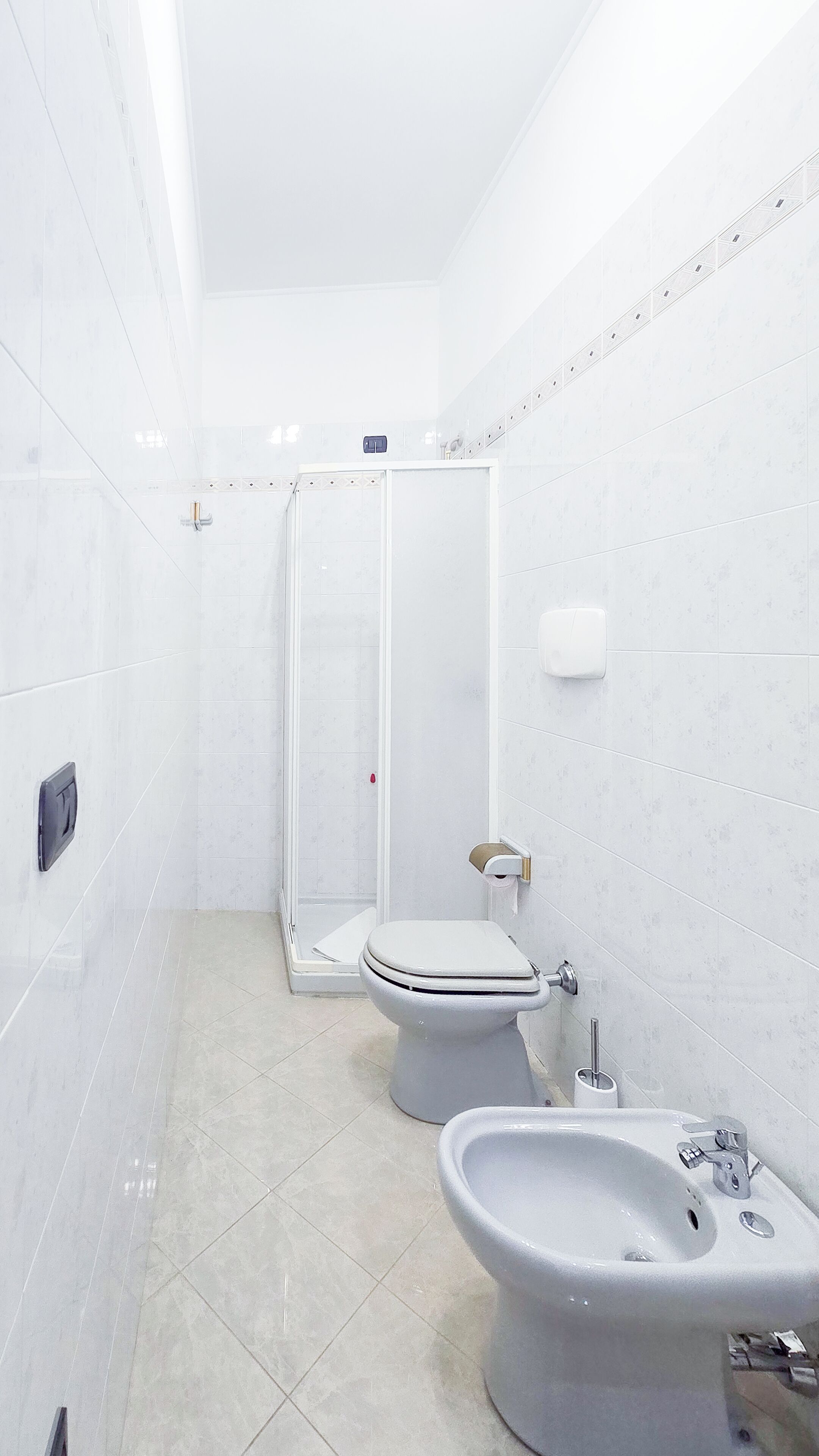 A modern bathroom with a toilet, bidet, and sink.