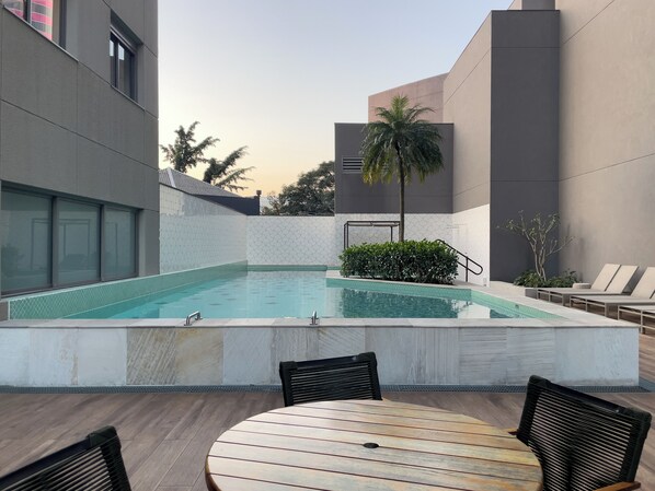 Outdoor pool, open 7:00 AM to 10:00 PM, pool umbrellas, pool loungers