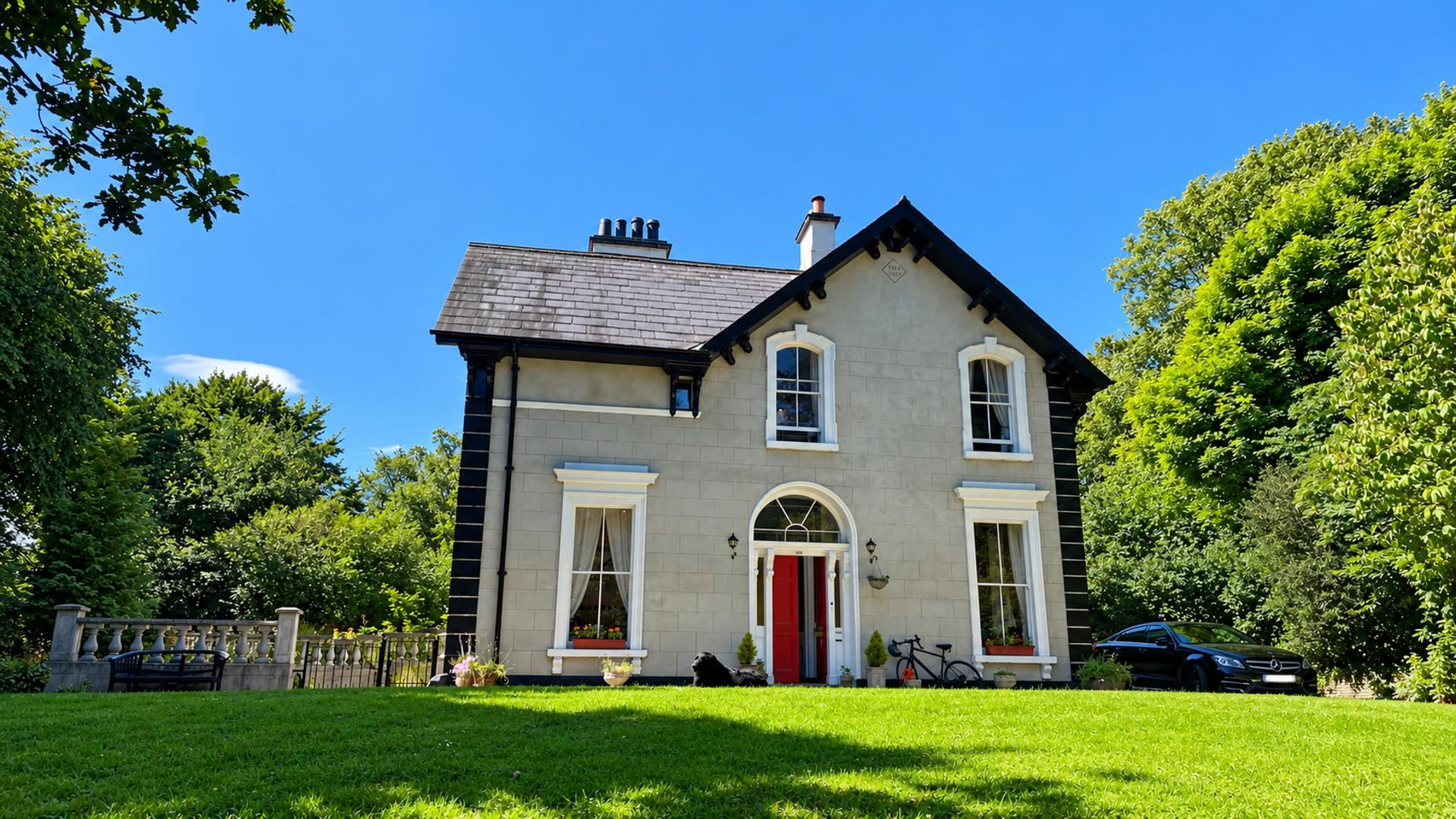 A two-story house with a red door, a chimney, and a well-maintained lawn.