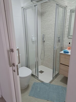 Shower, hair dryer, towels, soap