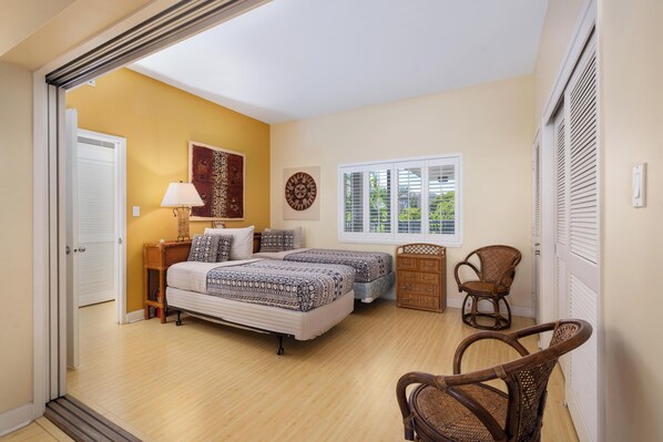 A bedroom with two beds, a wooden chair, a dresser, and a window with blinds. - Summer Deal Ocean View Condo 5 Min to A-Bay Beach and Resort Pool (Waikoloa Village)