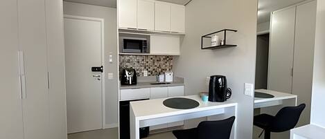 Fridge, microwave, coffee/tea maker, cookware/dishes/utensils