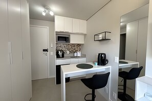 Fridge, microwave, coffee/tea maker, cookware/dishes/utensils