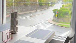 A modern room with a large window overlooking a street. - Lovely 1-bedroom apartment with Balcony, Wi-Fi, AC - only 30 mins to NYC (New Rochelle)