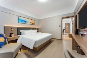 A modern hotel room with a large bed, bedside tables, a TV, and a painting on the wall. - Kaixuan Hotel Shennongjia (Shennongjia)