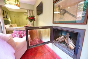 Deluxe Suite, 1 King Bed, Jetted Tub, Garden View | Living area | 42-inch Smart TV with digital channels, fireplace