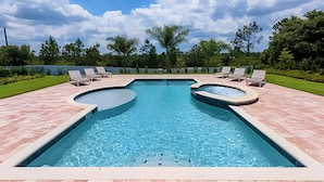 A rectangular swimming pool with two hot tubs, surrounded by a brick deck and lounge chairs. - Renovated Themed Bedrooms, Game Room, Pool (Kissimmee)