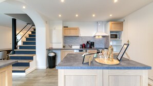 A modern kitchen with a central island, built-in microwave, and wooden cabinetry. - Dream Holiday Apartment - Casserousse - 18 Guests at the Foot of the Slopes (chamrousse)