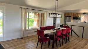 A modern kitchen with wooden cabinets, a stainless steel refrigerator, and a microwave. - Beautiful, newly renovated mountain home. (Golden)