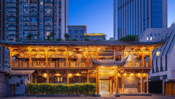 A traditional Chinese building with a wooden facade, large windows, and a sign for Days Hotel.