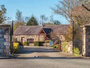 A stone building with a reception area, a gym, and a gated entrance.