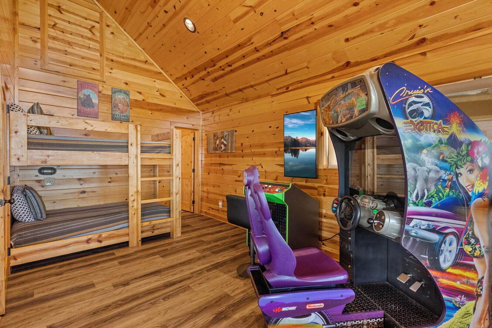 A cabin with wooden walls and floors, a bunk bed, a Nintendo gaming console, and a painting of a landscape.