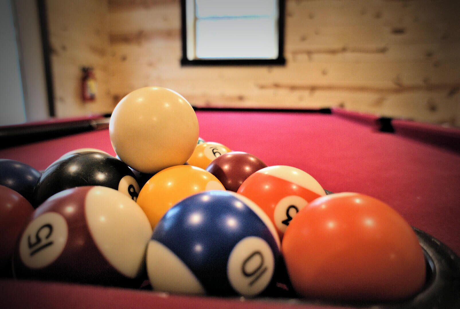 A pool table with various numbered billiard balls.