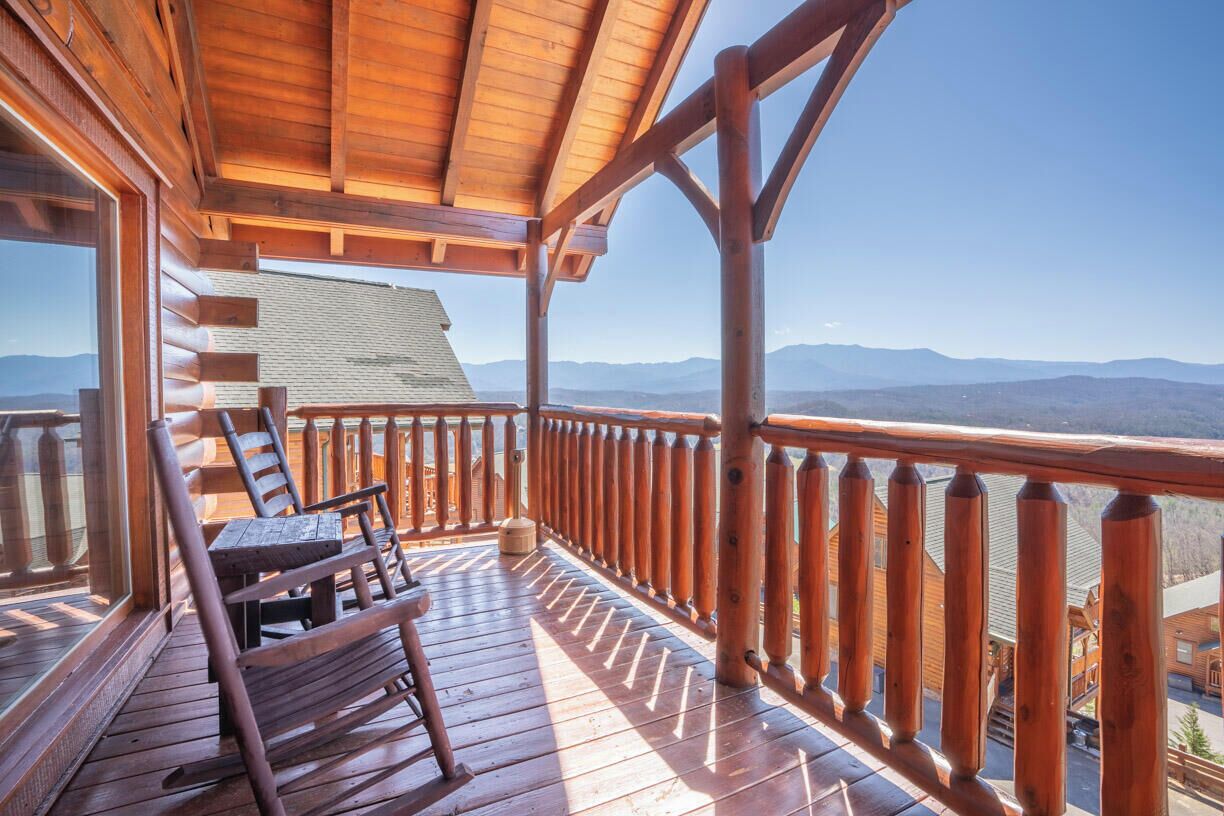 A wooden deck with a view of mountains.