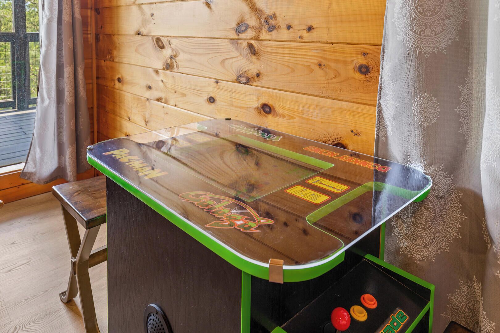 A wooden table with a glass top, a green edge, and a logo.