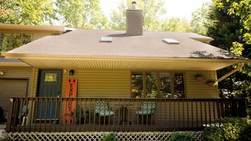 A two-story house with a covered porch, a chimney, and a garage.