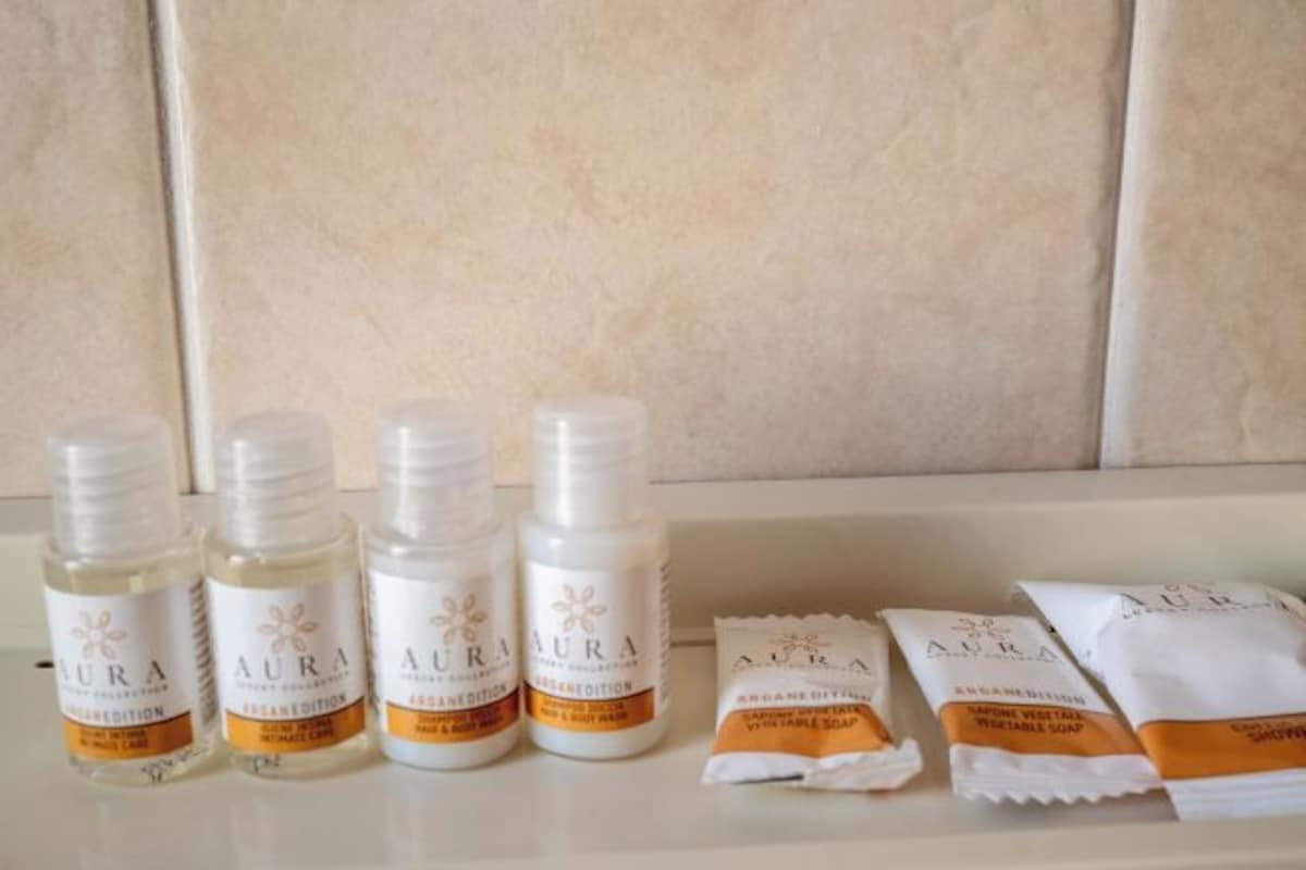 Bottles and packets of AURA products on a white surface.