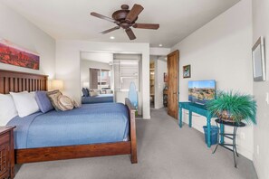 A regal queen bed, smart TV & patio access await in the second bedroom​