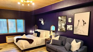 A modern bedroom with a bed, a sofa, a round table, and a decorative rug. - Freshly Remodeled Keystone Studio, Heated Pool, Hot tub, Walk to Gondola! (Keystone)