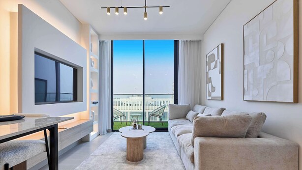 Un salon moderne avec une grande fenêtre, un canapé, une table basse et un téléviseur.