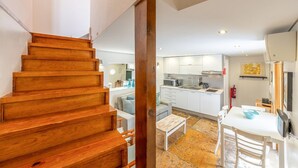 A modern kitchen with white cabinets, a built-in microwave, and a sink. - GuestReady - Alfama Terrace G (Lisbon)