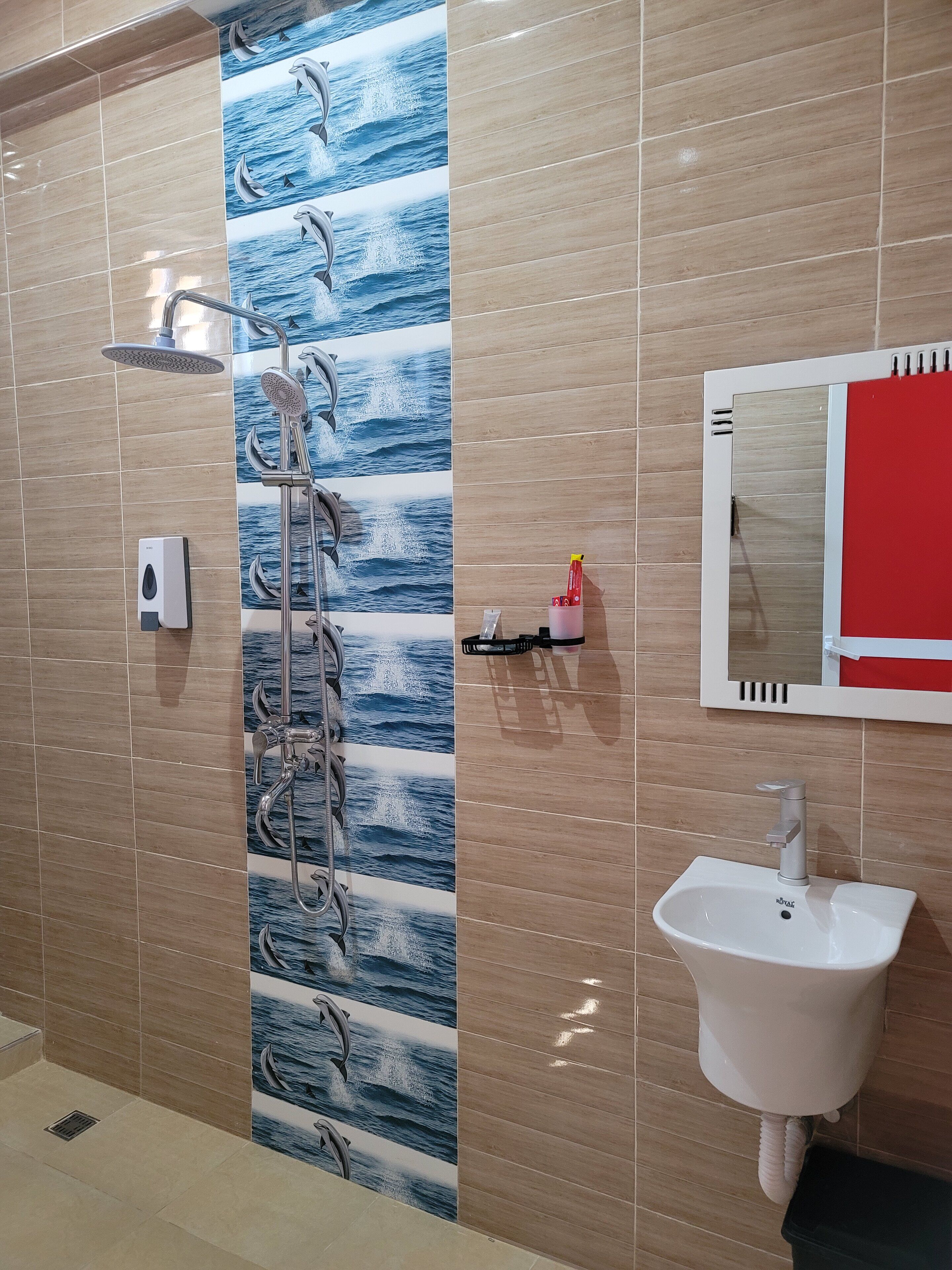 A bathroom with a shower, a sink, and a mirror.