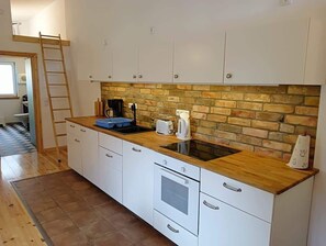 Fridge, stovetop, dishwasher, coffee/tea maker