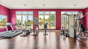 A gym with treadmills, elliptical machines, and weight equipment. - Family Getaway 3BR 2BA Lucaya Resort (Kissimmee)