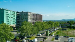 A parking lot with several cars and a few pedestrians. - Vienna Residence, Philips Haus - Euro Plaza #6556 (Vienna)