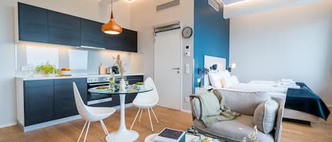 A modern apartment with a kitchen, dining area, and living room.