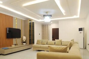 Junior Room, Balcony, City View | Living area | TV