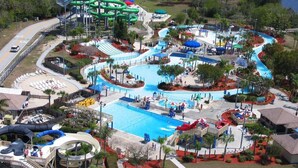 A water park with multiple slides, pools, and a large central pool area.