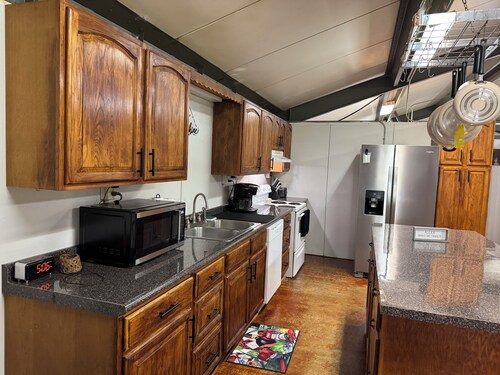 Unique camp style house with large wrap around deck.