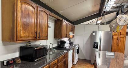 Unique camp style house with large wrap around deck.