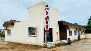 A hotel with a sign indicating AC and non-AC rooms are available. - Hotel Rewanchal (Khandwa)
