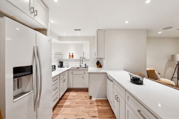 Fridge, stovetop, dishwasher, coffee/tea maker